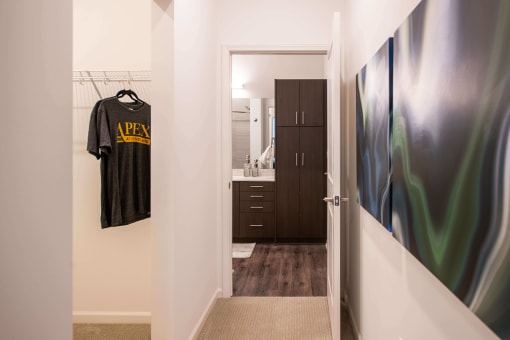 hallway with a view inside an open closet and bathroom door at The Apex at CityPlace, Overland Park