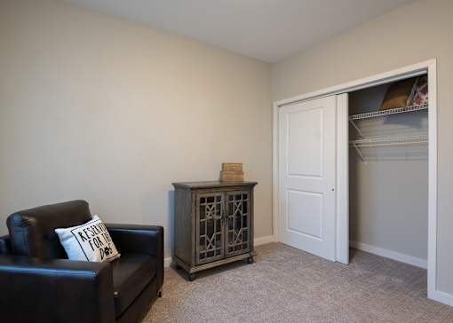 A guest bedroom at Aspen Ridge 55+ Apartment Community in Olathe, KS.