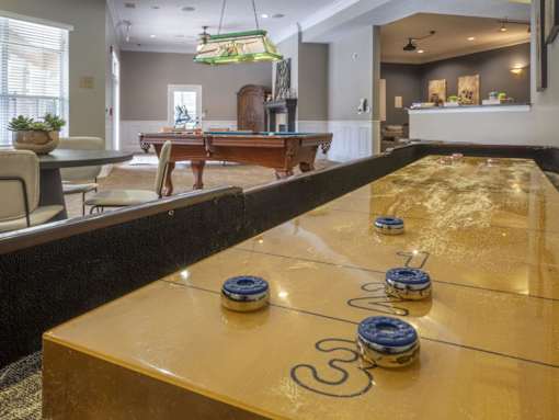 A pool table in a room with a billiard ball on it.