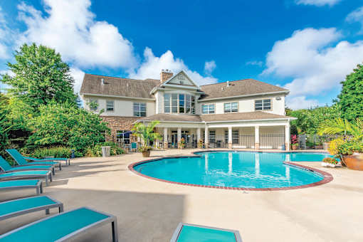 A large house with a pool in the backyard.