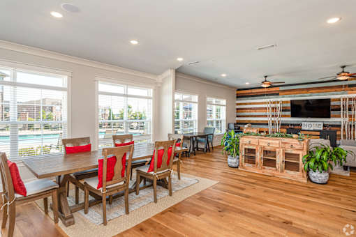 A dining room with a wooden table and chairs.