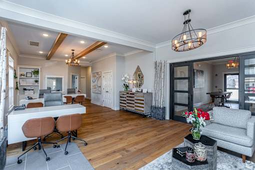 A modern home interior with a dining area, kitchen, and living room.