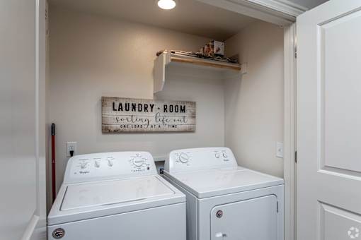 Two washing machines in a laundry room.