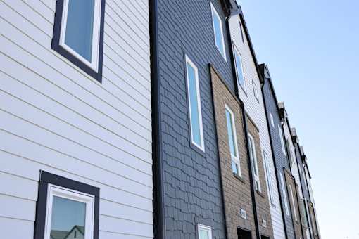 A building with alternating white and dark grey siding.