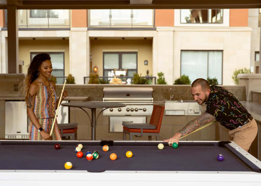 Couple playing pool at The Residences at Galleria