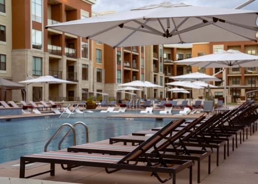 Pool deck with ample seating for sunbathing at luxury apartments in Overland Park