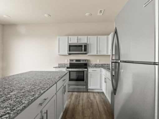 a kitchen with granite counter tops and stainless steel appliances at Hillcrest Village, Springdale, 72762