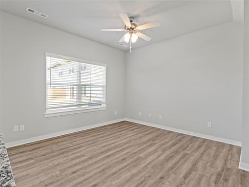 an empty living room with a ceiling fan and a window at Hillcrest Village, Arkansas, 72762