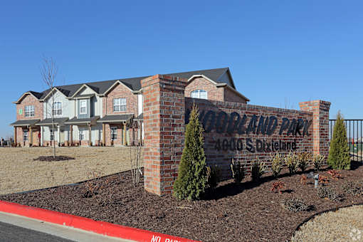 A brick sign that says "Bon Land Park" in front of a house.