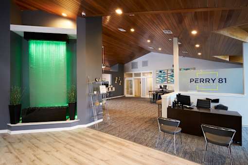 A modern office space with wood floors and a green accent wall.