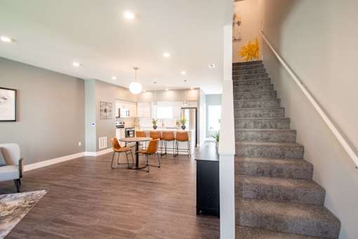 A living room with a dining table and chairs.