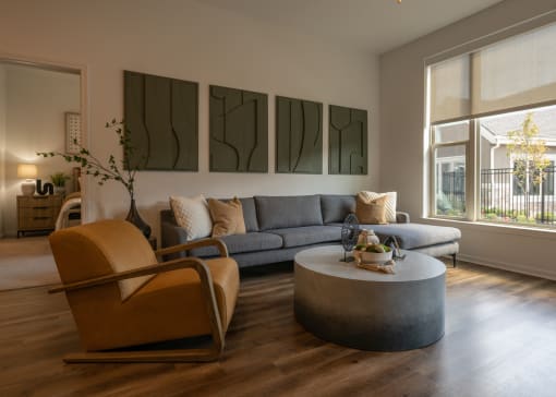 a living room with a couch and a coffee table  at The Clearing at ONE28, Olathe, KS
