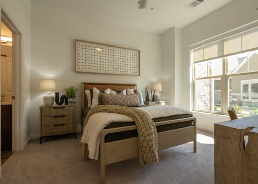 a bedroom with a bed and a large window  at The Clearing at ONE28, Kansas