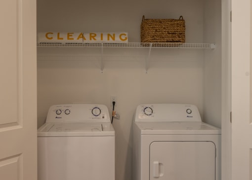 a laundry room with two washes and a dryer  at The Clearing at ONE28, Olathe, Kansas