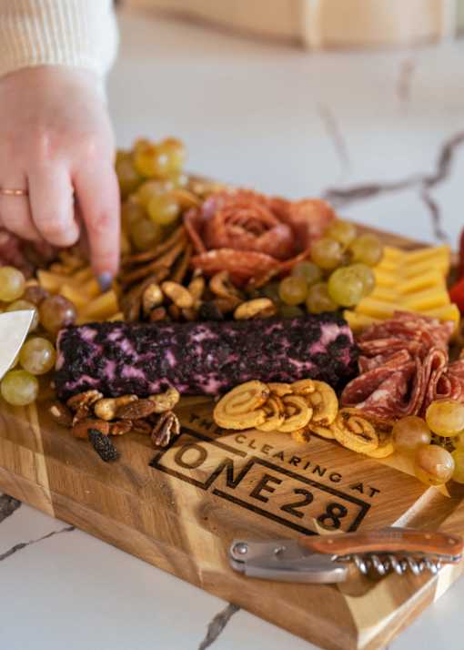 a board of cured meats and cheese on a cutting board at The Clearing at ONE28, Kansas