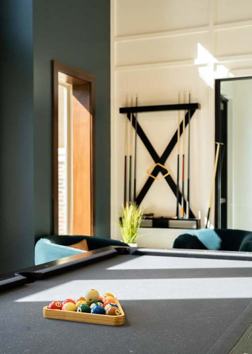 a pool table in a room with a tray of balls at The Clearing at ONE28, Kansas