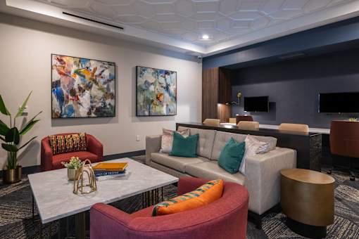 a living room with couches and chairs and a table at The Clearing at ONE28, Olathe, KS, 66062