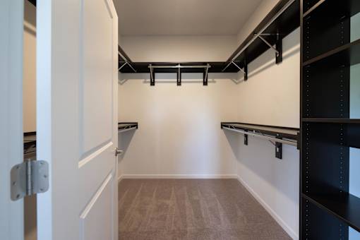 a walk in closet with empty shelves and empty belts at The Clearing at ONE28, Olathe, Kansas