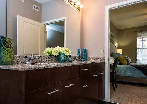 A bathroom with a vanity and a mirror.