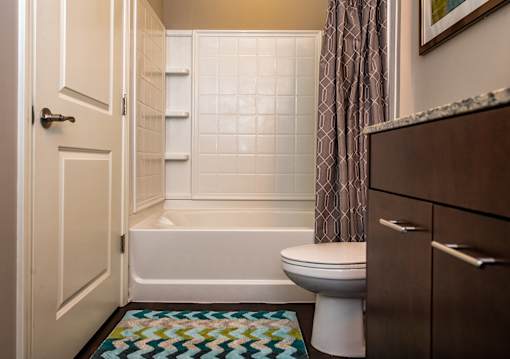 A bathroom with a toilet, tub, and sink.