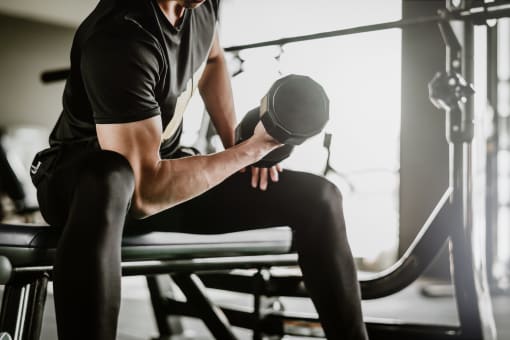 young man at the gym lifting a dumbbell free photo at The Crest at South Point, McDonough, 30253