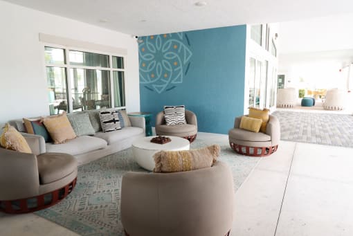 A living room with a white couch and a blue wall at The Crest at Laurel Canyon Apartments, Naples, 34113