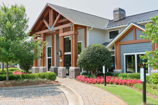 a home with a brick pathway leading to the front door at The Crest at Laurel Canyon Apartments, Canton