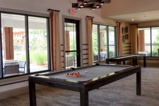 a game room with a pool table and a ping pong table at The Crest at Laurel Canyon Apartments, Canton, Georgia