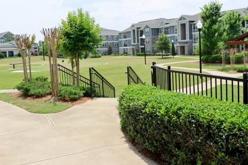 an apartment complex with a golf course in front of it at The Crest at Laurel Canyon Apartments, Canton, GA