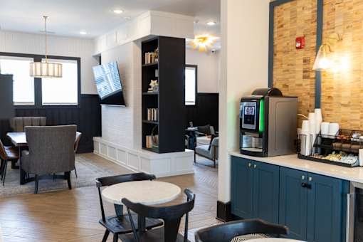 Community lounge with coffee bar and seating areas at The Crest at Acworth Apartments, Acworth, GA