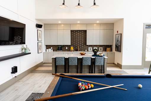 Game room with pool table and kitchen area at The Crest at Acworth Apartments, Acworth