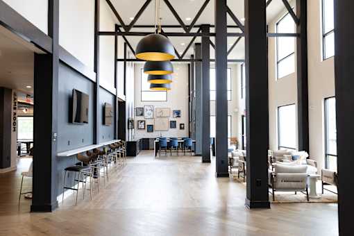 A large room with a long table and chairs at The Crest at South Point Apartments, Davenport , GA