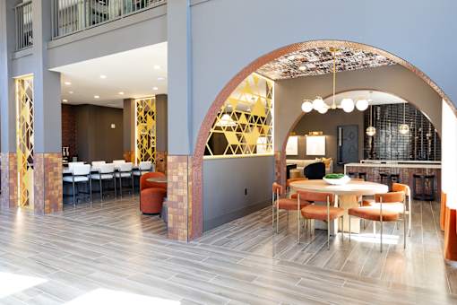 modern dining area with a curved archway at District on the Etowah Apartments, Canton Georgia