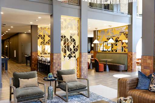 large room with a lot of chairs and tables at District on the Etowah Apartments, Canton, 30114