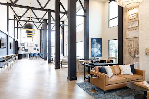 A large room with a couch and a table at The Crest at South Point Apartments, Davenport , GA, 30253