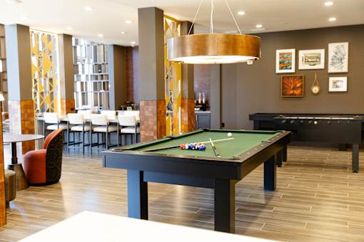 billiard table is in the middle of room at District on the Etowah Apartments, Canton