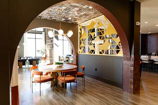 A dining room with a round table and chairs. at District on the Etowah Apartments, Canton, GA 30114