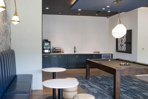 A room with a pool table and a bar. at The Crest at South Point Apartments, McDonough