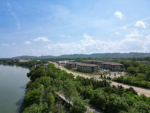 A large building complex sits on the bank of a river.