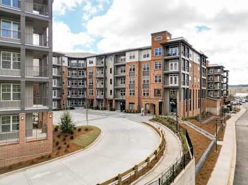 Apartment buildings with a curved driveway in front.