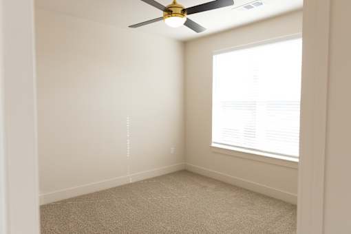Lively bright room with ceiling fan at District on the Etowah Apartments, Canton, GA
