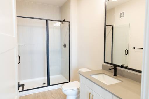Personalized bathroom with modern sink design at District on the Etowah Apartments, Canton, 30114
