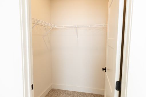 Open-plan airy closet with shelf system at District on the Etowah Apartments, Georgia