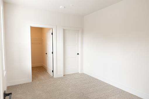 Illuminated spacious room with grey carpet at District on the Etowah Apartments, Canton Georgia