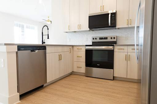Eco-friendly bright kitchen with cabinet storage at District on the Etowah Apartments, Georgia, 30114