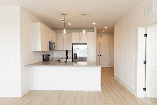 modern kitchen with a white island at District on the Etowah Apartments, Canton, 30114