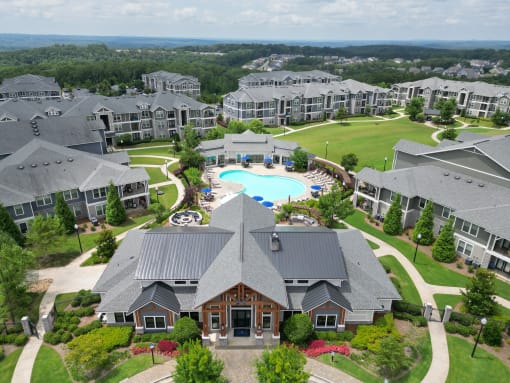 an aerial view of a large complex with a swimming pool and golf course at The Crest at Laurel Canyon Apartments, Canton, 30114