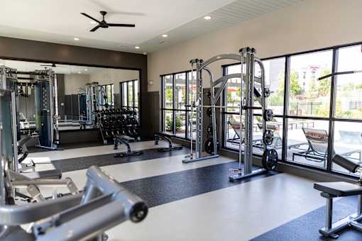Fitness center with cable machines and free weights at The Crest at Acworth Apartments, Georgia, 30102