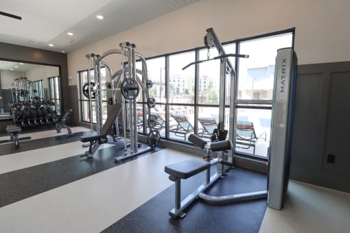 a gym with exercise equipment and windows in a building at The Crest at Acworth, Acworth, 30102