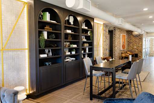 modern dining room with a brick wall at District on the Etowah Apartments, Canton, 30114